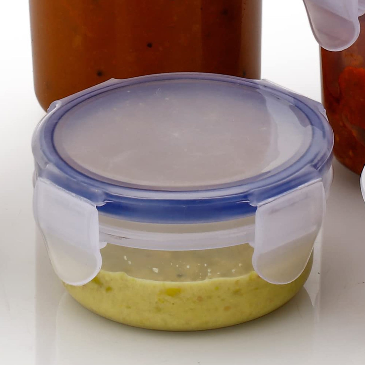 Transparent round food storage container with secure lid and airtight seal. Transparent round food storage container with secure lid and airtight seal.